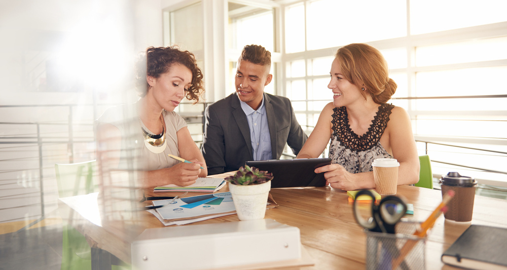 Image of three business people during at meeting